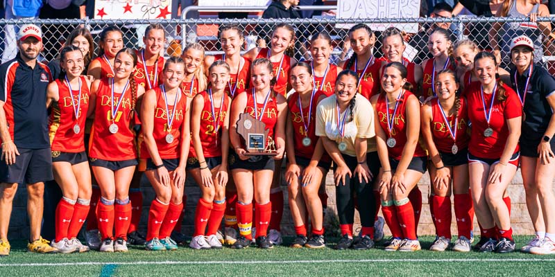 Picture of Divine Savior Holy Angel Field Hockey Team in red uniforms after winning the state championship